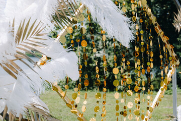 Wall Mural - Decorated wedding arch in nature.Wedding ceremony with an arch decorated with feathers in retro style