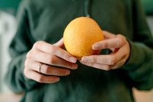Businesswoman Holding Fresh Orange In Office