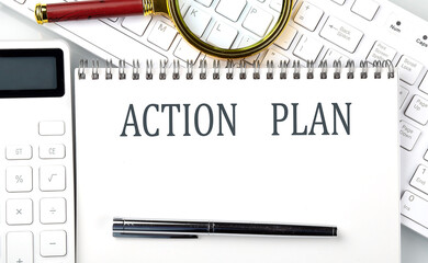 Poster - ACTION PLAN Text on the notepad with calculator and keyboard