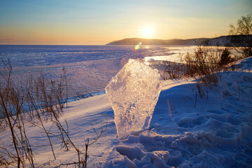 Sunset on Lake Baikal. Ice floe on the background of a beautiful sunset.