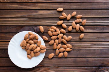 Sticker - almonds in a bowl on a wooden background