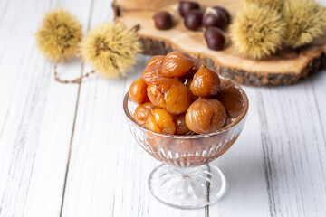 Wall Mural - Chestnut dessert and chestnuts on a plate. Traditional delicious Turkish dessert; chestnut candies (Kestane Sekeri)