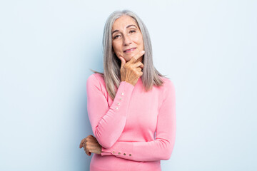 Wall Mural - middle age gray hair woman looking serious, thoughtful and distrustful, with one arm crossed and hand on chin, weighting options