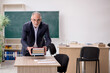 © Elnur - Old male teacher in front of blackboard