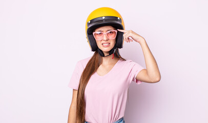 Poster - young pretty woman with a motorbike helmet.