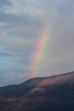 Fototapeta Tęcza - Rainbow starting over the mountains