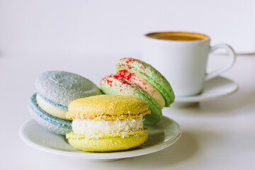 Wall Mural - set of macaroons with flowers and coffee cup in cafe