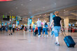 © Наталия Бражник - people wearing medical masks walking with luggage bags suitcases at the airport travel concept. High quality photo