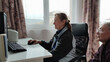 © Anna - an elderly couple looks at the computer interesting video