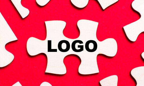 On a bright red background, white puzzles. In one of the pieces of the puzzle, the text LOGO