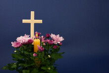 Composition Of Burning Candle, Flowers And Wooden Cross For All Souls Day. Also Suitable For Funeral, Mourning, Grief.