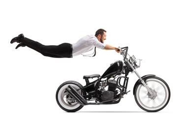 Poster - Man holding onto a chopper motorbike and flying