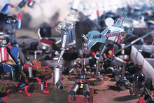 A Crowd Of Robots In A Junkyard. A Group Of Robots, From Radio Components, Playing Musical Instruments. Abstraction From Radio Parts