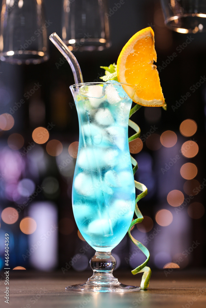Glass of Blue Lagoon cocktail on table in bar