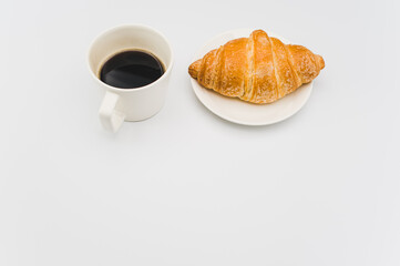 Sticker - sweet and tasty croissant and black coffee cup on white with space for text