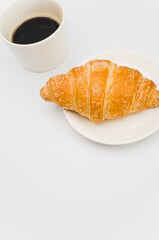 Sticker - fresh and buttery croissant in a plate on a white background