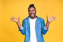 Cheerful Handsome African American Black Man Making Yes Gesture While Excited About Winning. Ecstatic Young Fan Rooting And Expressing Support. Success Concept Isolated Over Yellow Background.