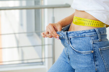 Woman In Oversize Jeans After Weight Loss, Diet Concept.