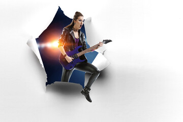 Wall Mural - Young and beautiful rock girl playing the electric guitar