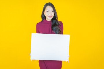 Wall Mural - Portrait beautiful young asian woman with empty white billboard