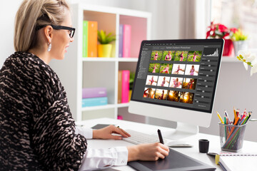 Leinwandbilder - Woman working with digital photo library on desktop computer and editing photos