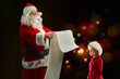 © alphaspirit - Santa Claus searches from a list a gift for a child