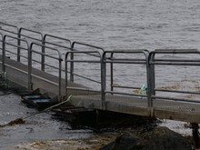 Metallic Pier With Metal Handrails At The Shore