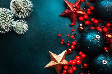 Wall Mural - Blue Christmas or New Year background with blue Christmas balls, red berries and stars, top view, place for text