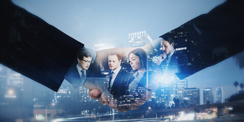 Poster - Close up of abstract handshake with businesspeople working on bright city background. Teamwork and cooperation concept. Double exposure.