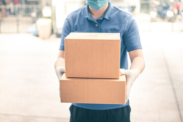 Food delivery from store to door. Courier in medical gloves gives products to client at home, cropped.  express delivery, quarantine, virus outbreak, takeaway food delivery concept.