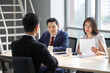 © iammotos - group of business people in suits and Human resources manager female interviewing new worker or employee . serious interviewer woman in job interview