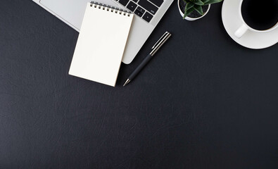 Wall Mural - Top view above of Black leather office desk table with keyboard laptop computer, notebook with equipment other office supplies. Business and finance concept. Workplace, Flat lay with blank copy space.