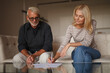 © Andrii Zastrozhnov - Mature couple signing divorce document. Senior family separation, problems between husband and wife. Marriage contract.