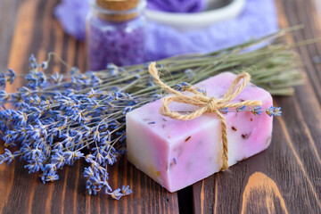 Wall Mural - Lavender spa products on wooden table. Body care products with lavender: soap, salt and dried lavender flowers. Selective focus.