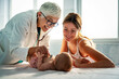 © NDABCREATIVITY - Pediatrician doctor examines baby. Healthcare, people, examination concept