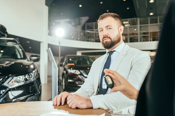 Canvas Print - Car dealer giving keys from new auto to diverse couple