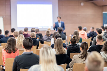 Business speaker giving a talk at business conference event.