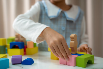 Children's are playing logical toy learning shapes arithmetic and colors at home,Kindergarten or nursery.