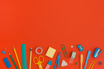 School stationery on a red background. Top view with copy space. Flat lay. Back to school concept.	
