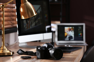Poster - retoucher's workplace. professional camera and lamp on table indoors