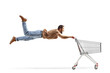 © Ljupco Smokovski - Casual man flying and holding a shopping cart