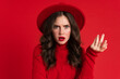 © Drobot Dean - White displeased woman wearing hat gesturing and looking at camera