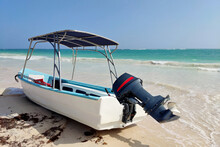 Motorboat With Canopy On A Sandy Beach On Azure Sea Background. Holidays And Travel On A Paradise Coast