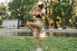 © etonastenka - Side view shot of fit young woman doing cardio interval workout in the park at sunrise. Fitness woman working out outdoors in the morning