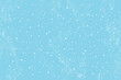 Winter snowfall and snowflakes on light blue background. Hand drawn snow pattern. Doodle cold winter sky background.