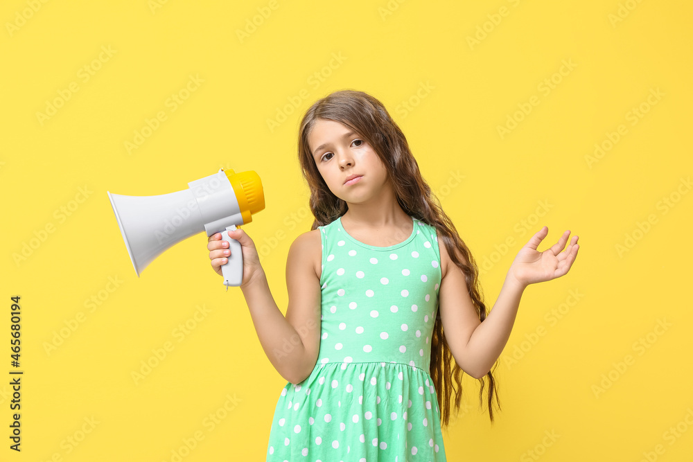 Little girl with megaphone on color background