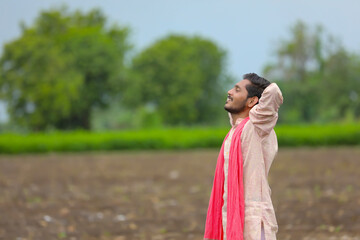 Wall Mural - Young indian farmer spreading hand at agriculture field.