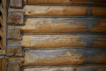 Photo of a log house , a wall of logs, an old building texture, background for design