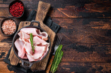 Prosciutto Ham Sliced In A Pan. Dark Wooden Background. Top View. Copy Space