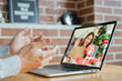 © chinnarach - close up man using video call to talking and greeting with girlfriends in ornamental living room at home for christmas celebration and people technology concept